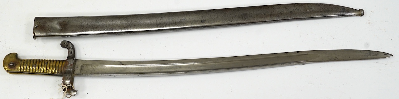 An 1855 French bayonet in its scabbard. Condition - good